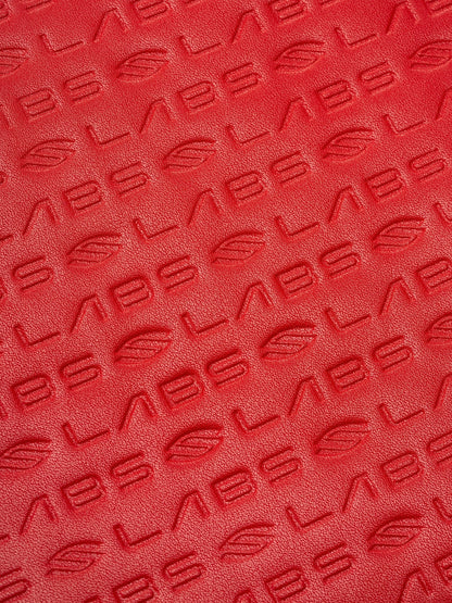 Close-up of the red textured InfiniGrit carbon fiber surface on a Pickleshop Selkirk Labs Project Boomstick paddle.