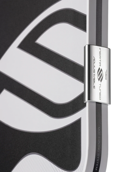 Pickleshop Selkirk Omni pickleball paddle edge showing the adjustable MOI tuning system weight on a black background